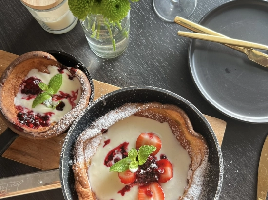 Dutch Baby with champagne whipped cream and fresh berries